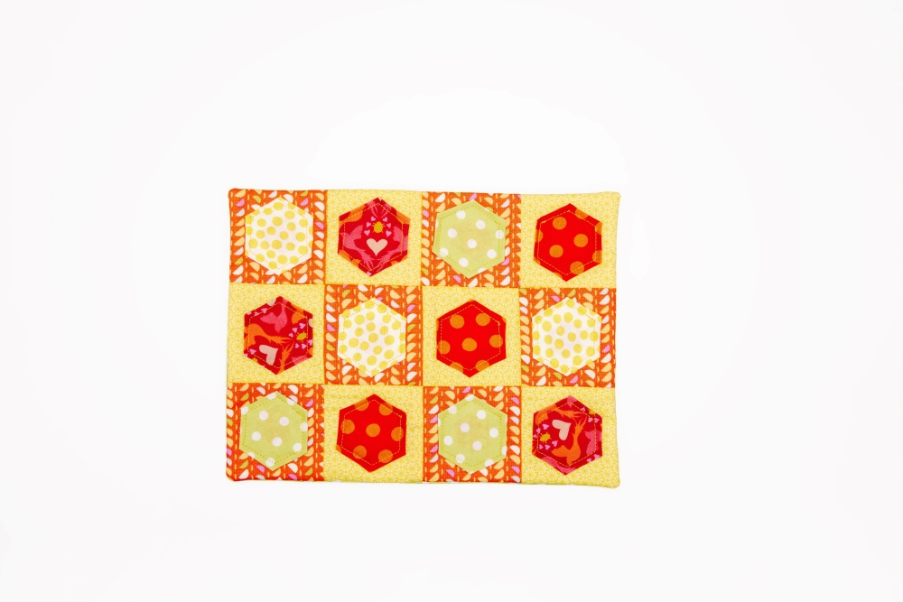 Mug rug with hexagon embellishments